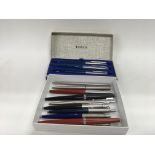 A collection of vintage Parker and paper make pens