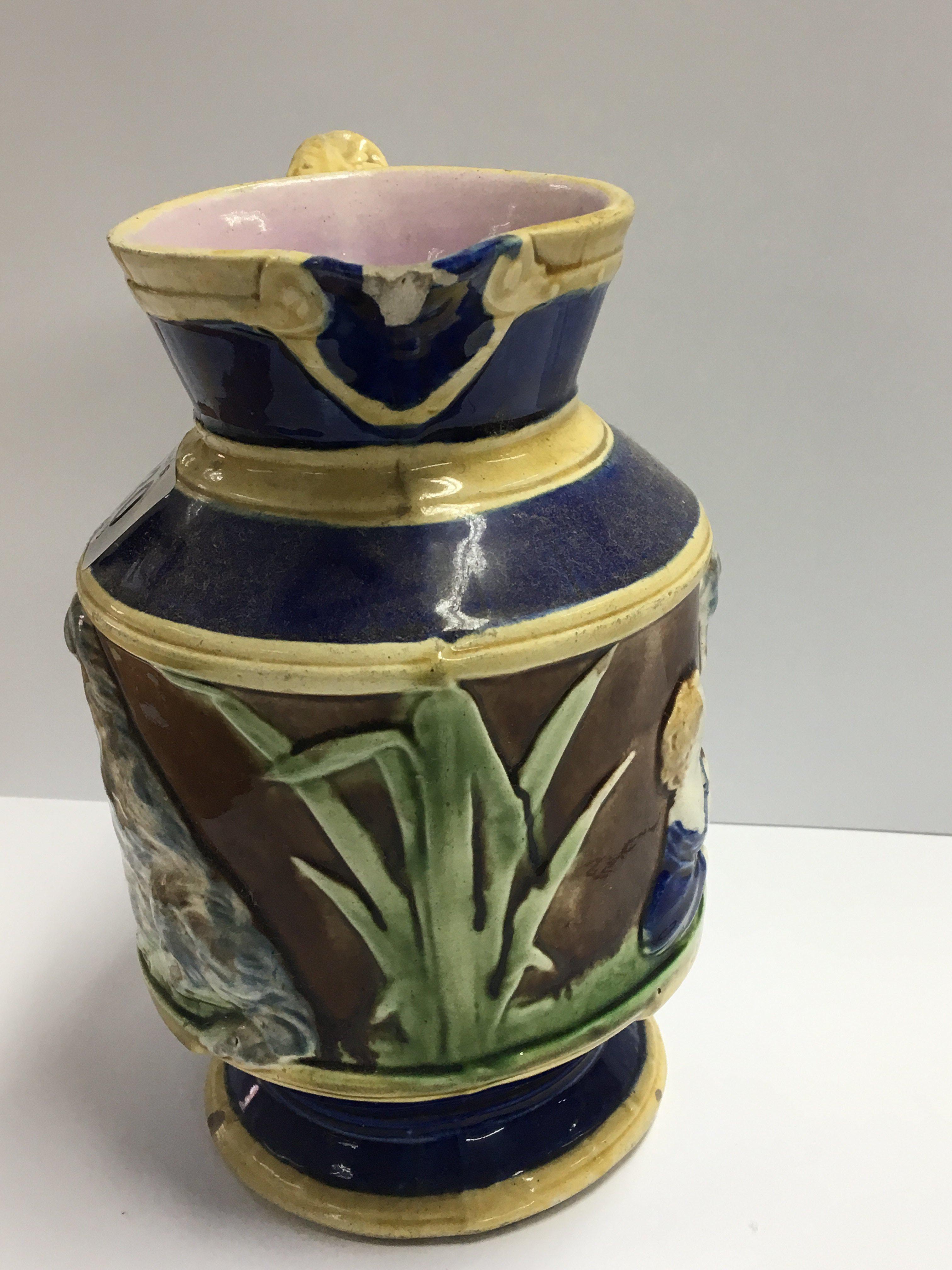 A 19th century Majolica jug decorated with a boy w - Image 2 of 3