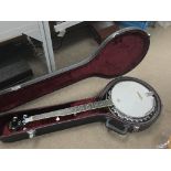 A hard cased Remo Washburn banjo.