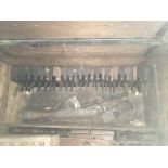 A carpenters chest containing a large collection of woodworking planes and carpentry tools