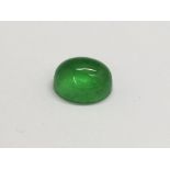 A polished spinach jade cabouchon stone. Approx 1.