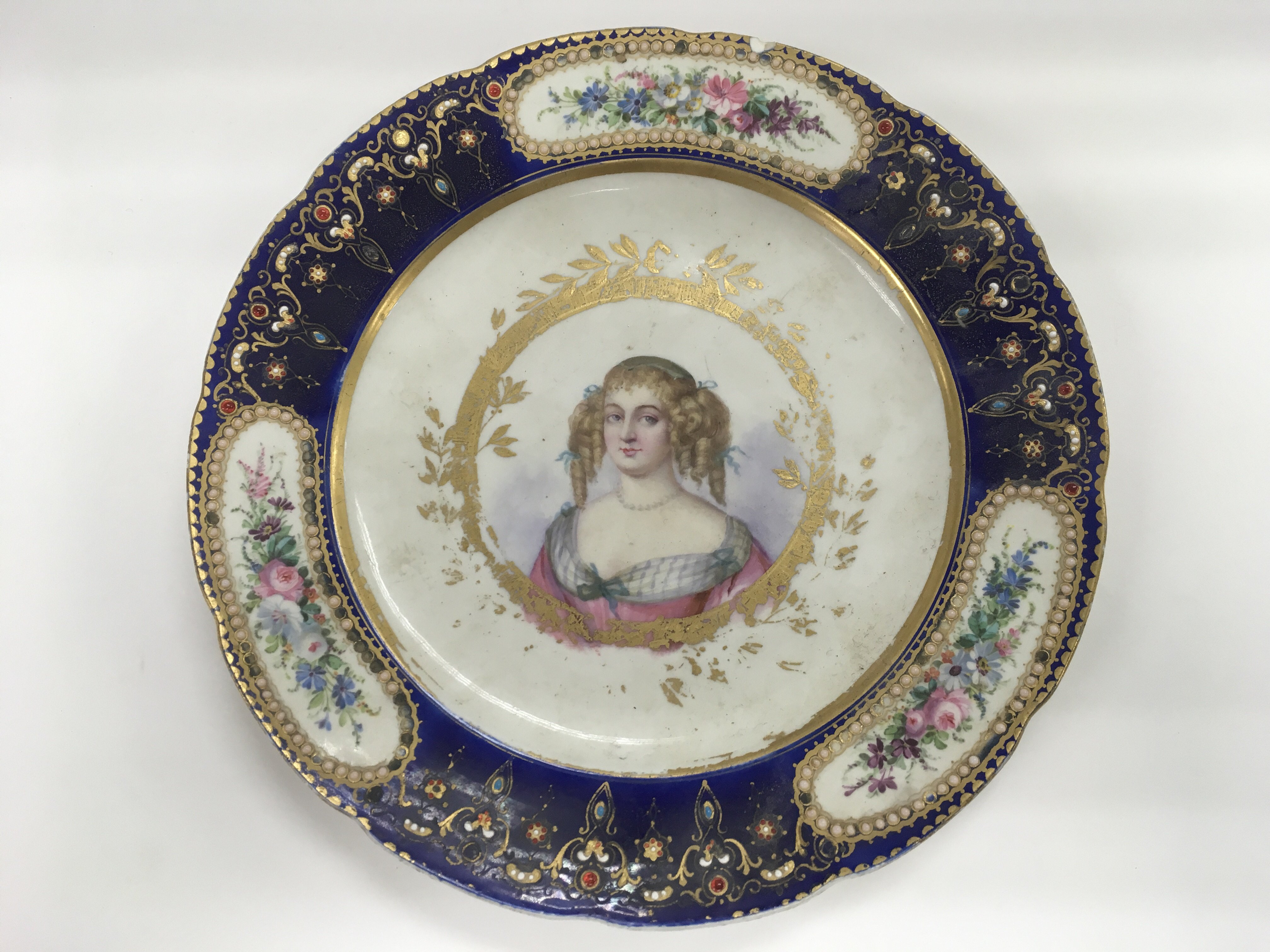 A Sevres plate, the centre depicting a transfer pr