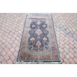 A part silk Persian style rug, with blue field and