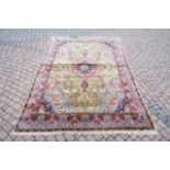 A large part silk brightly coloured carpet with a