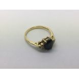 An 18ct gold ring set with possibly a sapphire and