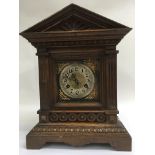 A oak cased mantle clock The silvered dial with Ar