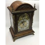 A large Edwardian oak bracket clock with gilt meta