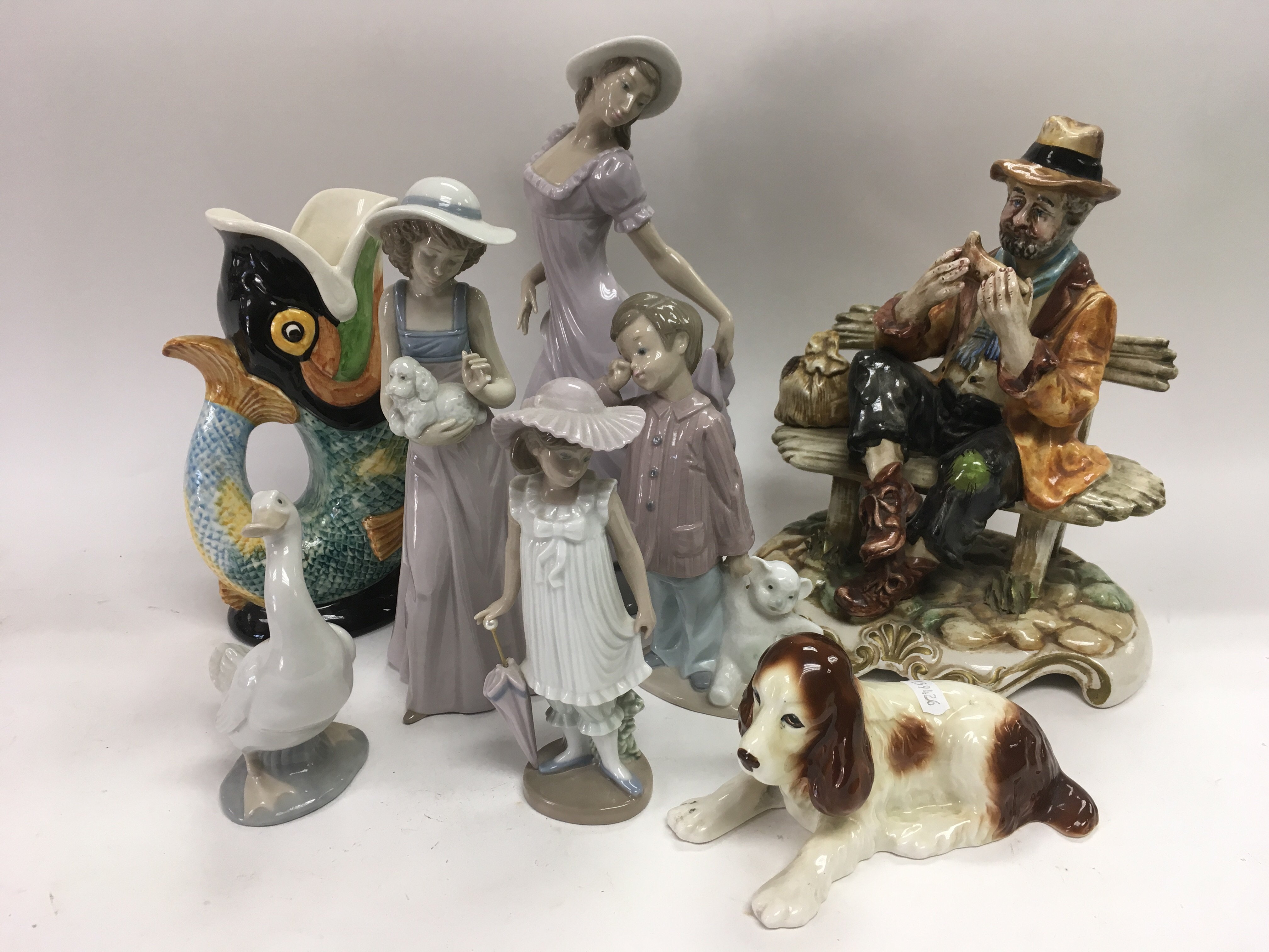 A collection of ceramics including Nao figures, a