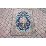 A Persian style part silk rug with blue field flor