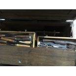 A tool chest containing a collection of woodworking chisels
