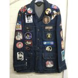 A 1970s Lee denim jean jacket adorned with various