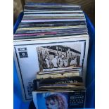 A box of LPs and 7 inch singles by various artists including James Taylor, Eagles, Sam Cooke and