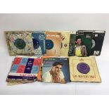 A small collection of 7 inch singles by various artists including Elvis Presley, The Ventures and