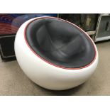 A circa 1970s quirky design pod chair, the low seated white plastic pod had a black leather type