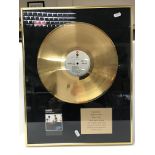 A framed and glazed gold disc for the classic albu