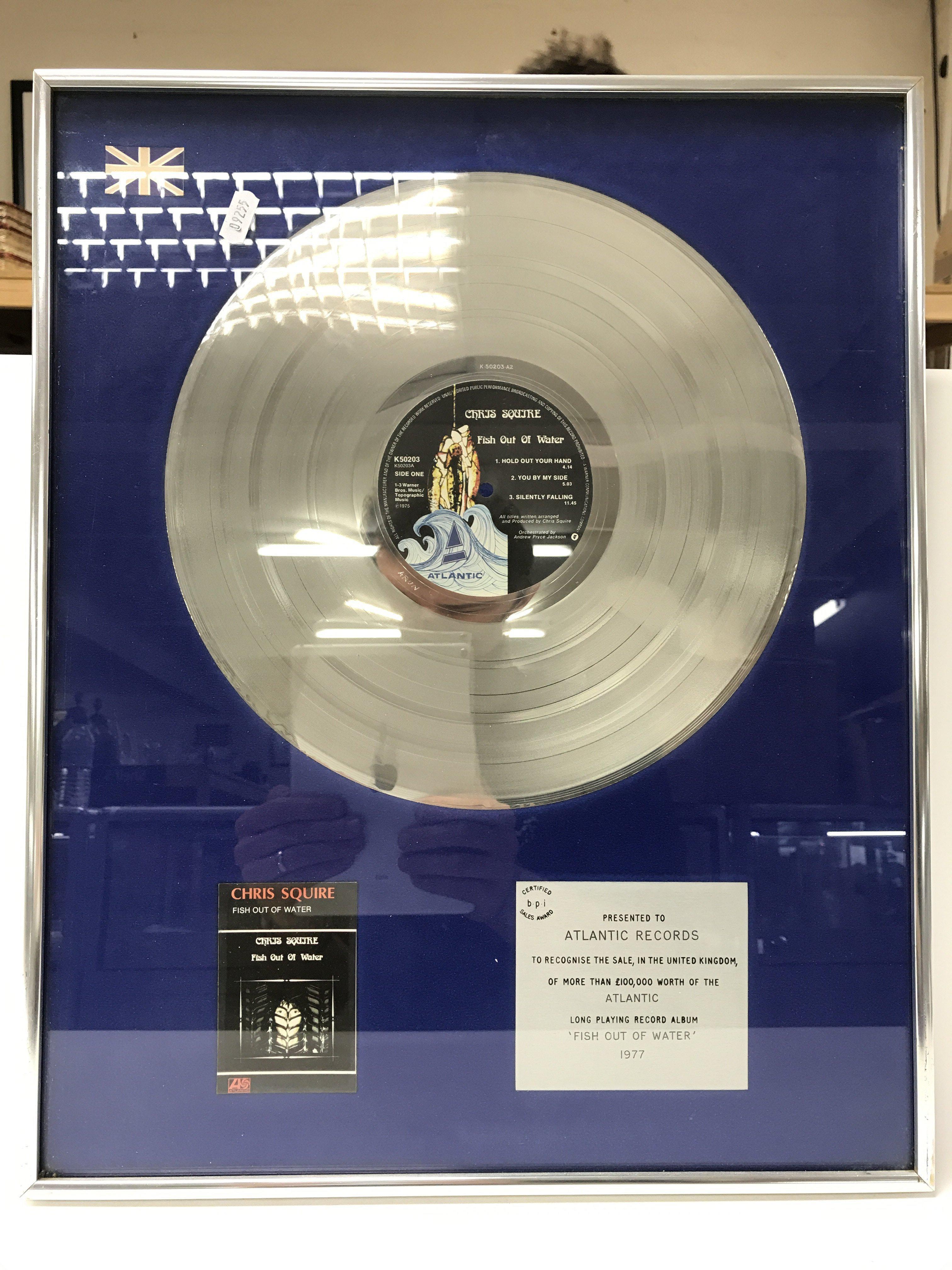 A framed and glazed silver disc presentation of th