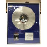A framed and glazed silver disc presentation of th