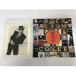 A signed 10"x8" black and white photograph of Elton John together with a book of 'Rock Album