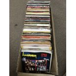 A small box of 7 inch singles comprising mainly rock n roll and heavy metal.