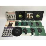 A collection of Beatles 7 inch singles and EPs.