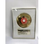 A framed and glazed gold disc commemorating sales