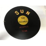 A handpainted metal sign for 'Sun Records', Memphis, Tennessee in the form of a large record.
