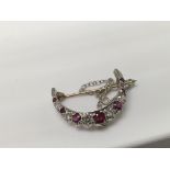 A Edwardian crescent brooch inset with diamonds an