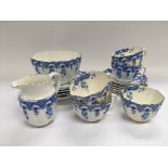 An Edwardian blue and white tea set with scalloped
