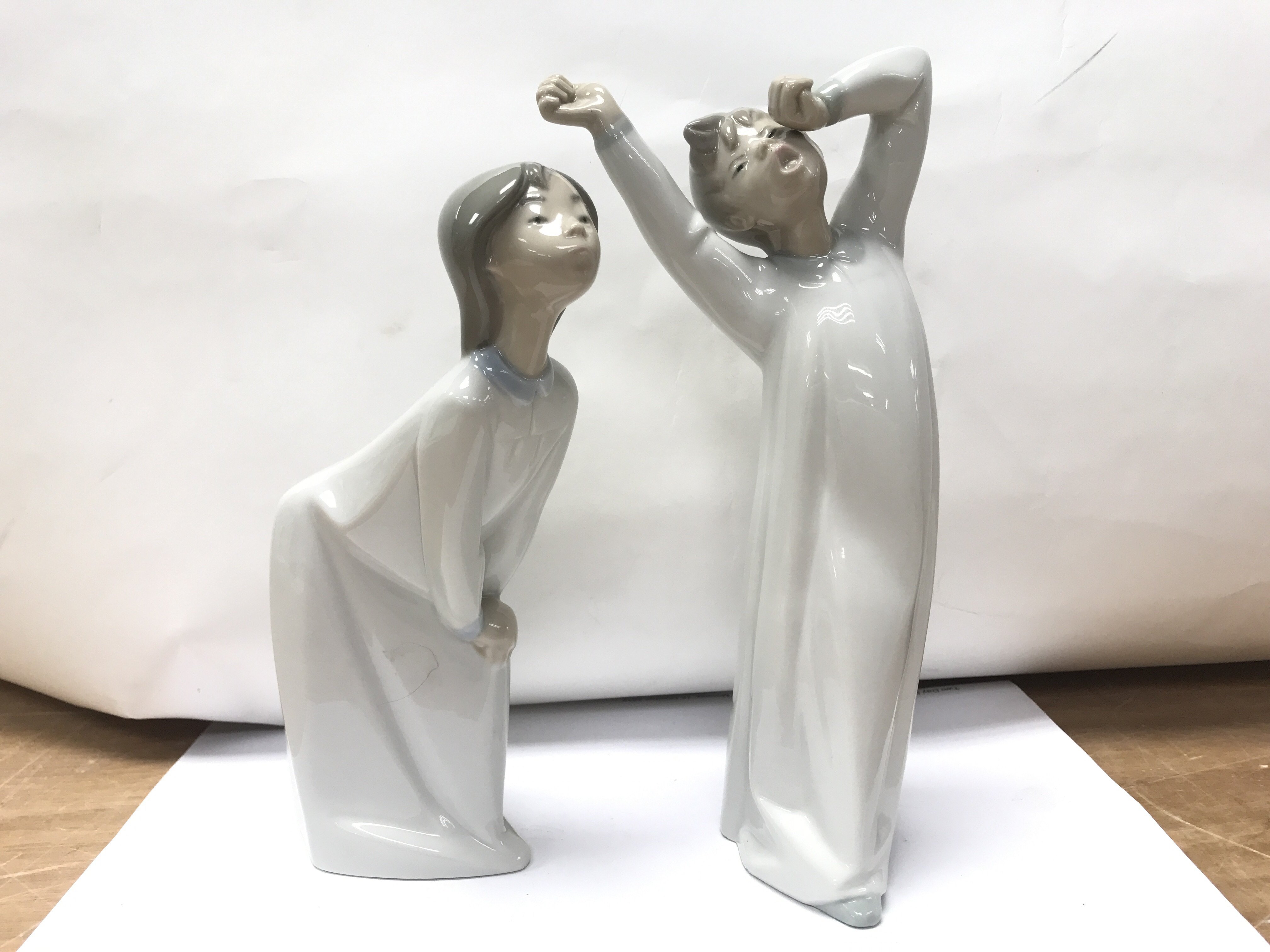 A pair of Lladro figures of bed time.