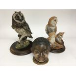 A late 19th Century bisque type jar in the form of a black boy and two Country Artist figures of