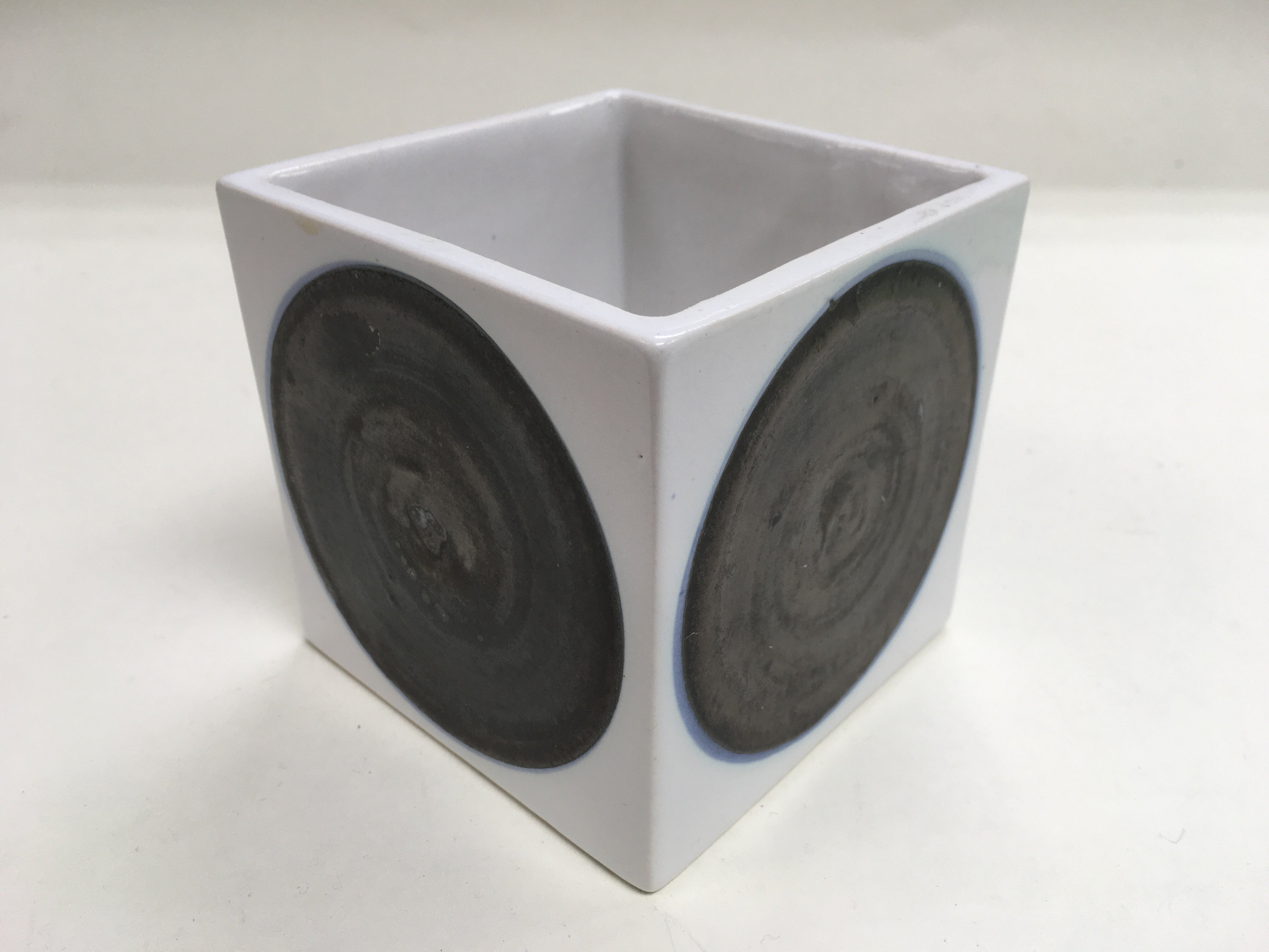 A Troika cube vase with black circular decoration