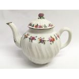 A 19th century teapot of fluted form with painted