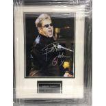 A framed and glazed photograph of Elton John with