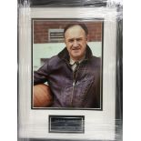 A framed and glazed photograph of Gene Hackman wit