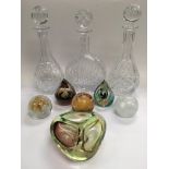 A collection of glass items comprising three decan