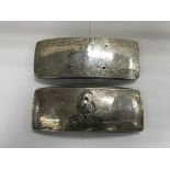 A pair of silver military lander dispatch pouch co