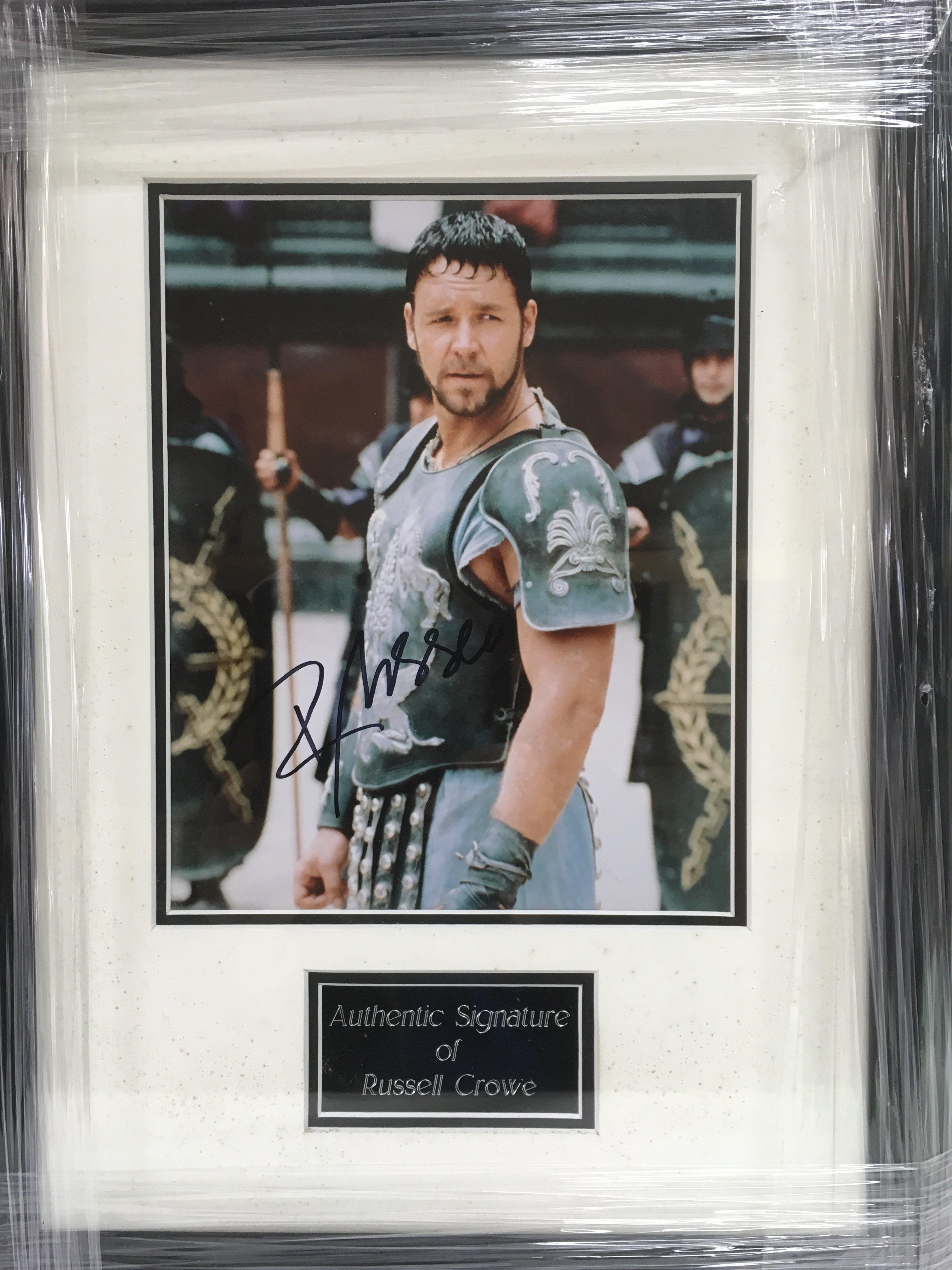 A framed and glazed photograph of Russell Crowe wi