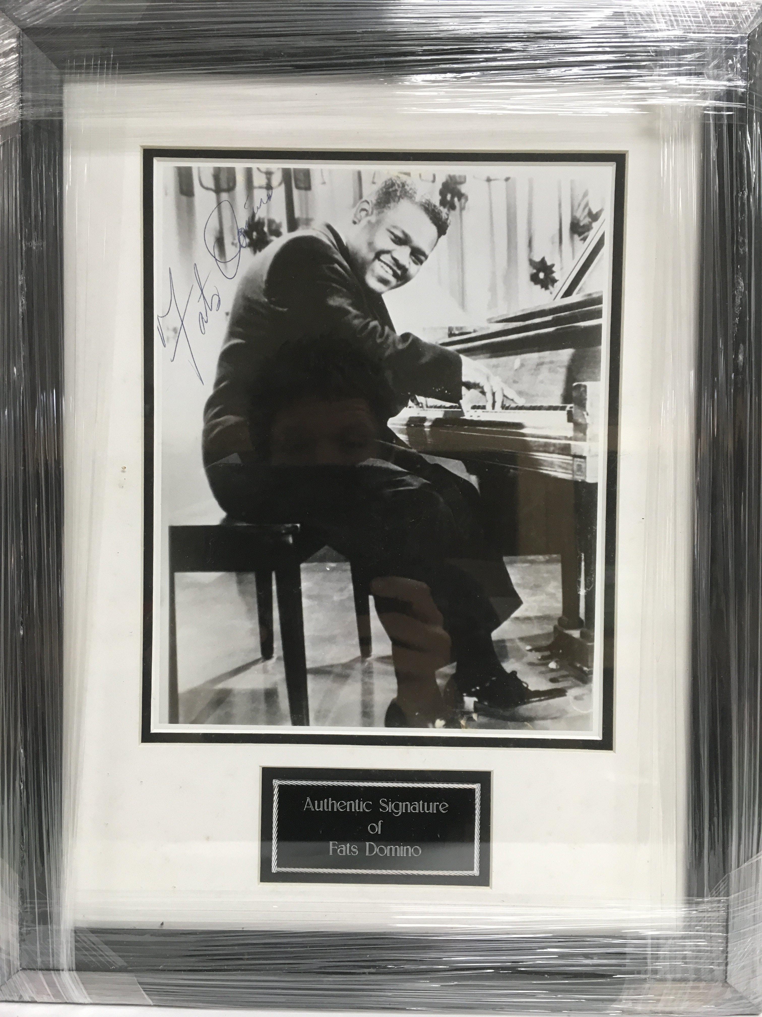 A framed and glazed photograph of Fats Domino with