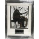 A framed and glazed photograph of Fats Domino with