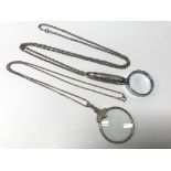 2 magnifying glasses; 1 silver on silver chain and