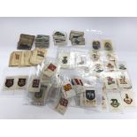 A collection of various cigarette cards and silks.