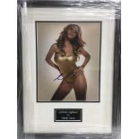 A framed and glazed photograph of Mariah Carey wit