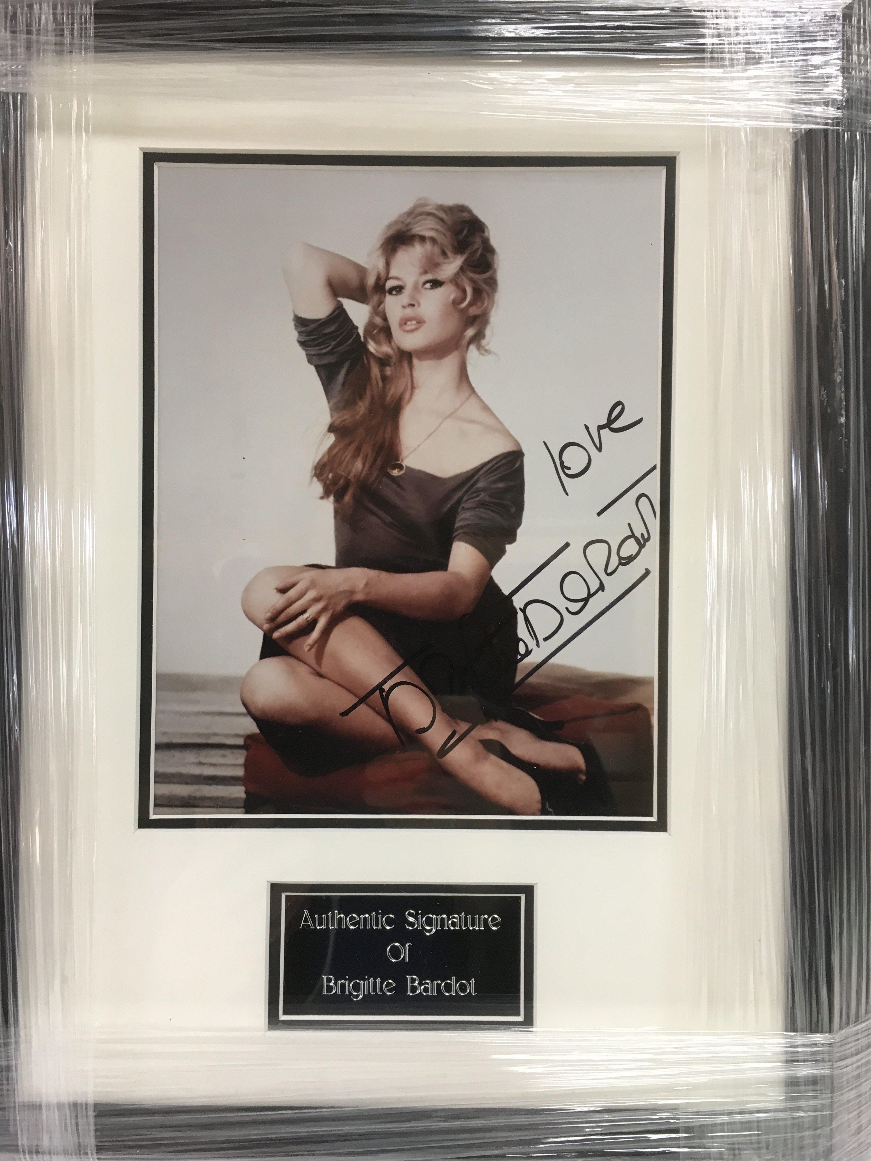 A framed and glazed photograph of Brigitte Bardot