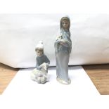 A Lladro figure of a girl and a shepherd boy.