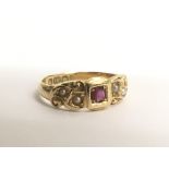 An antique gold ring stamped 18, inset with a ruby