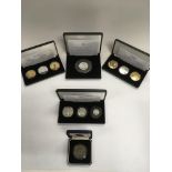 Five cases of Jubilee Mint silver and gold plated coins.