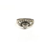 An antique silver friendship ring with central hea