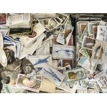 A large box of various cigarette cards to include