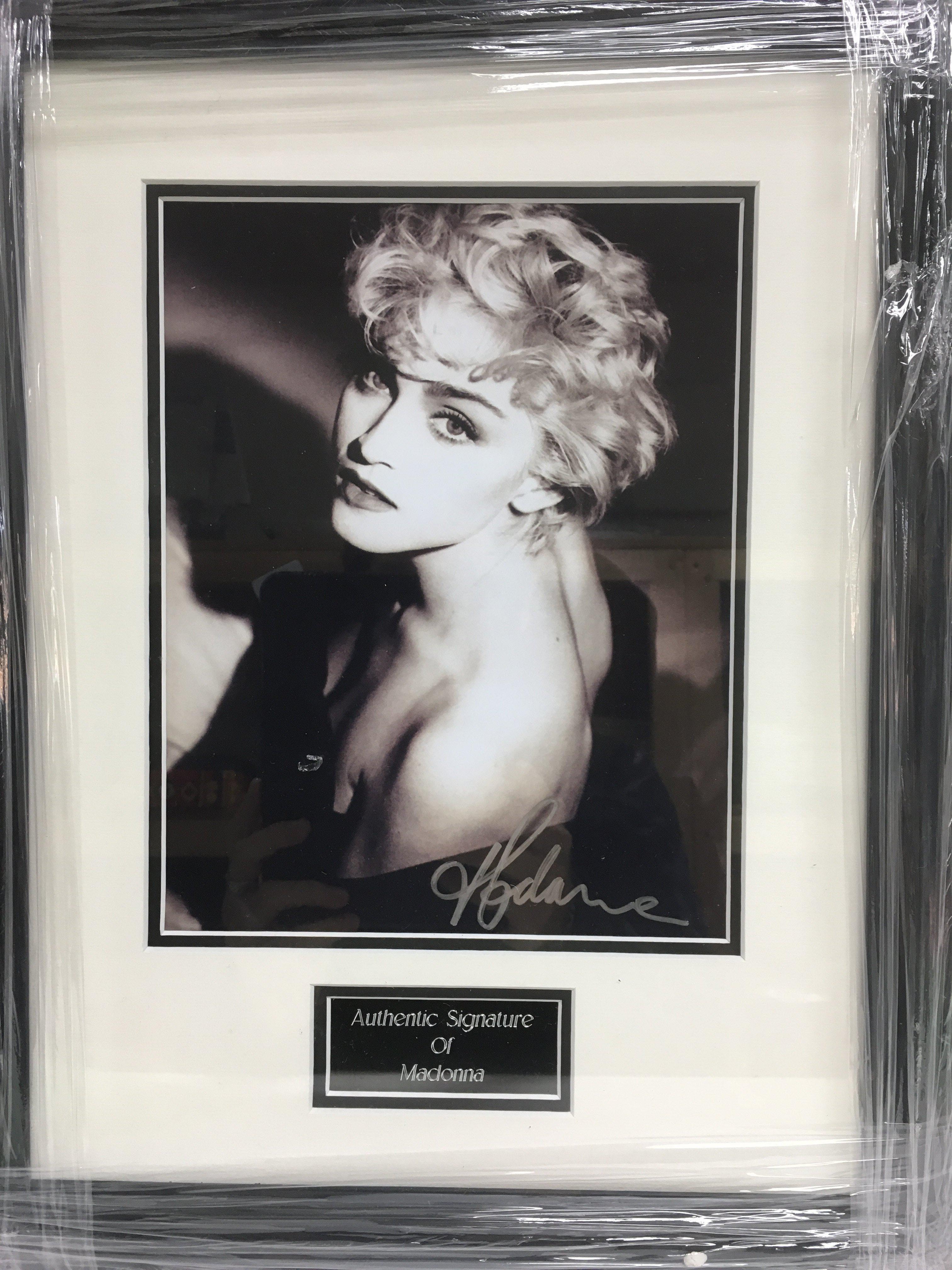 A framed and glazed photograph of Madonna with att