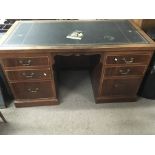 A Mahogany Desk the top inset with leather and fit
